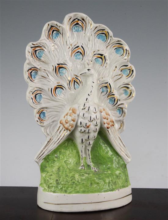 An unusual Staffordshire pottery flatback peacock figure, mid 19th century, 29.5cm.